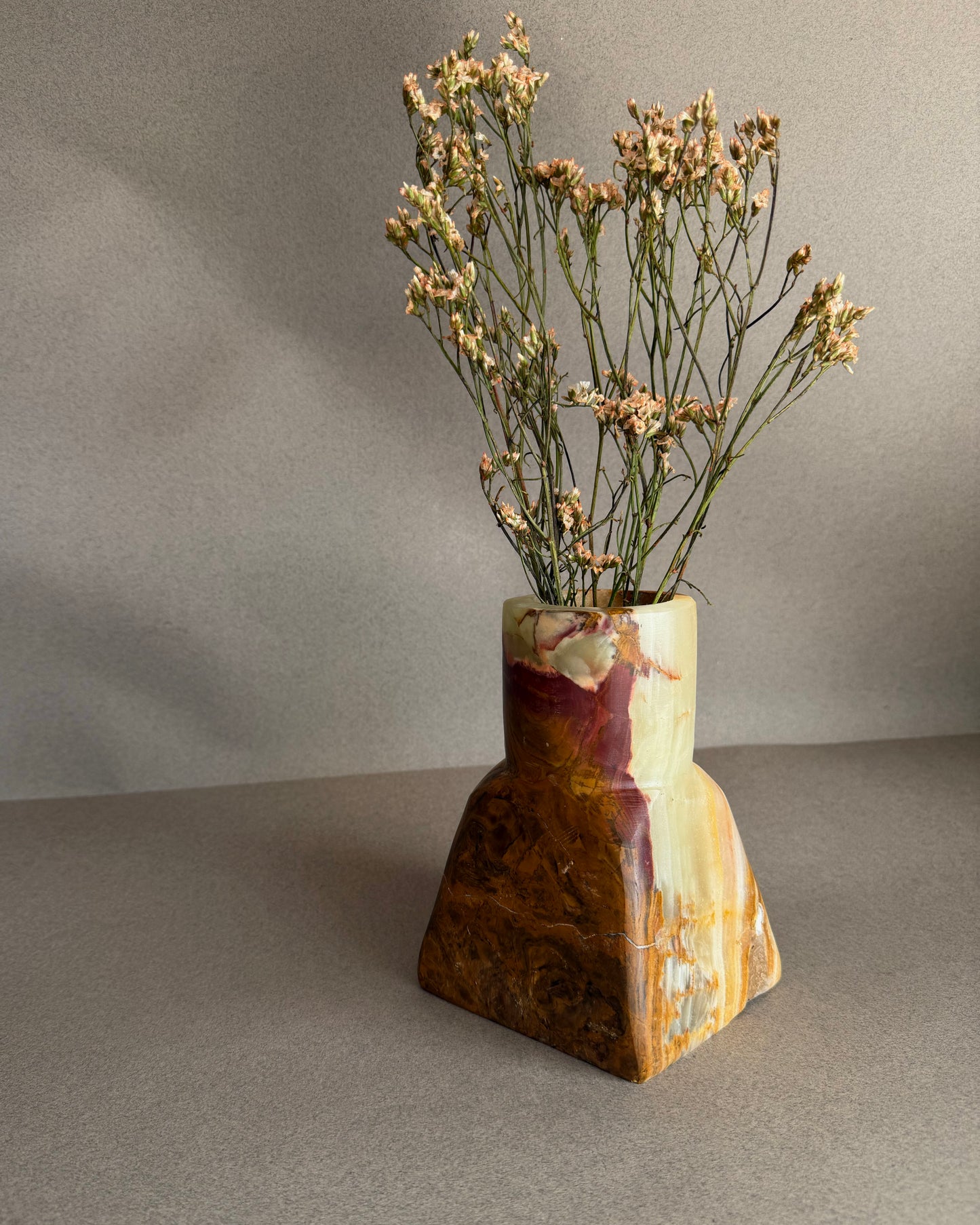 Sculptural onyx dune vase featuring flowing green stone and earthy brown banding, handmade stone vase
