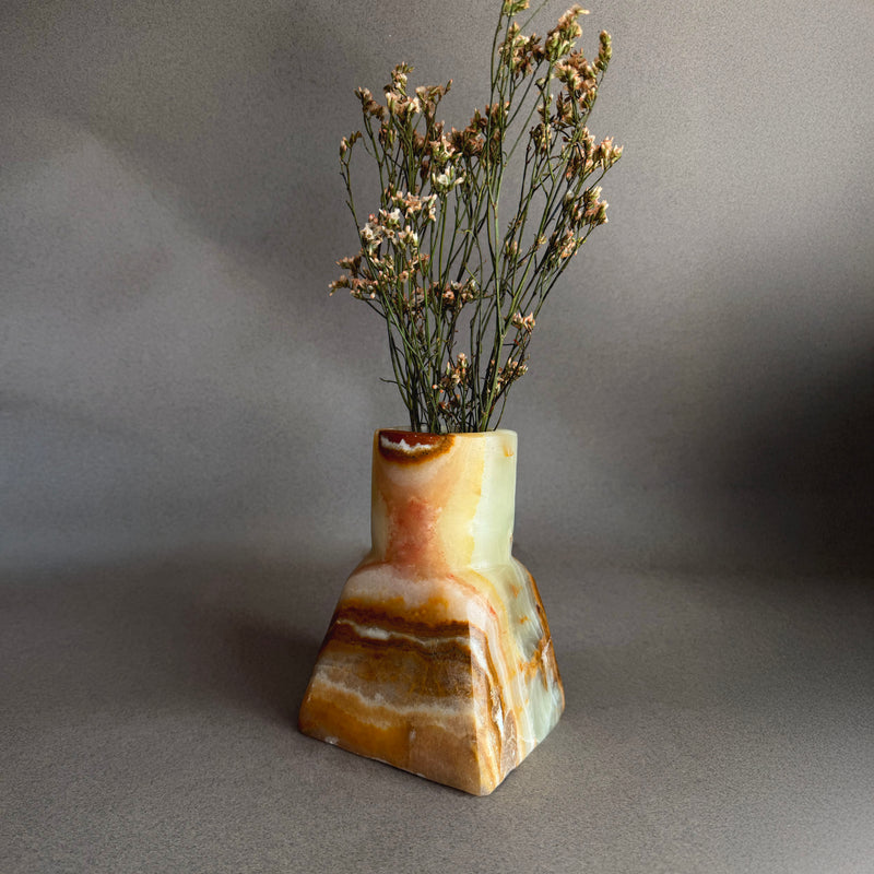 Close up of raw onyx vase highlighting organic veining, mineral layers, and natural stone texture

