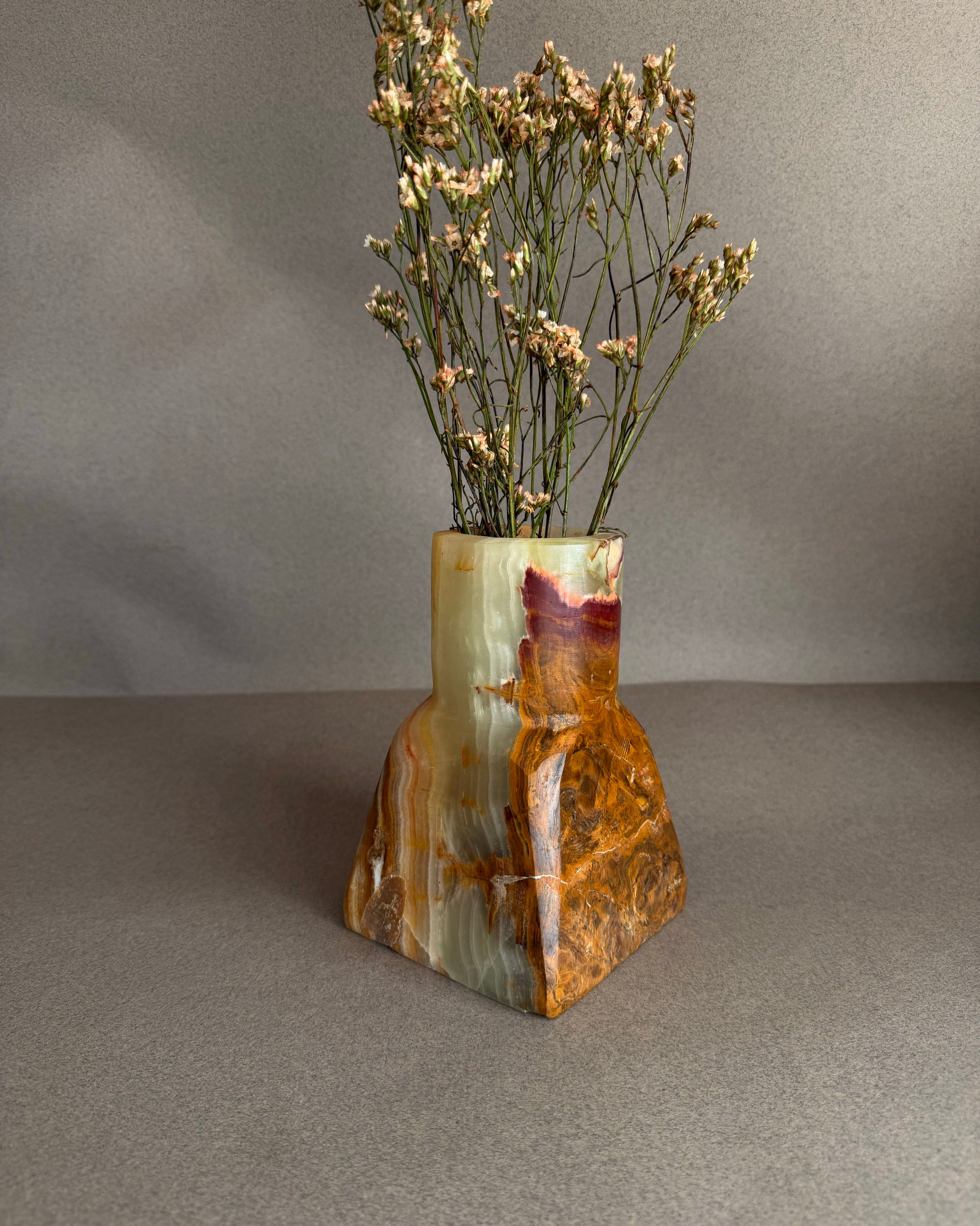 One of a kind onyx vase carved from solid stone, green, brown, and golden amber color variation
