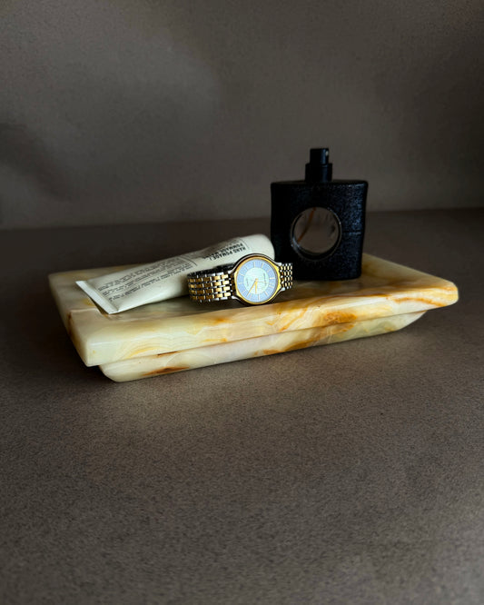Hand-carved peach and honey onyx catchall tray with soft amber veining, rectangular stone tray photographed on neutral background
