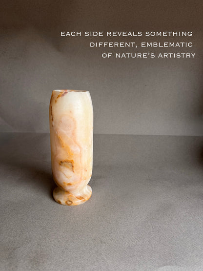 Decorative peach white orange honey stone vase on a gray background with text about nature's artistry.