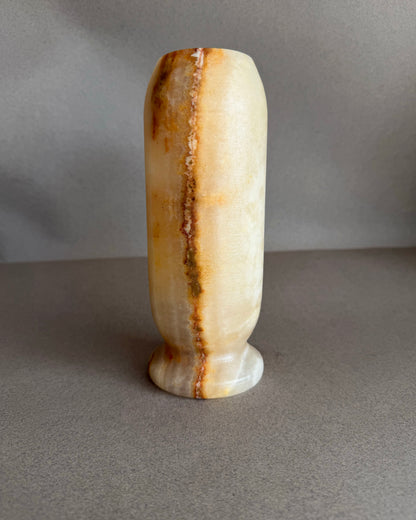 Decorative vase with brown and beige patterns on a gray background