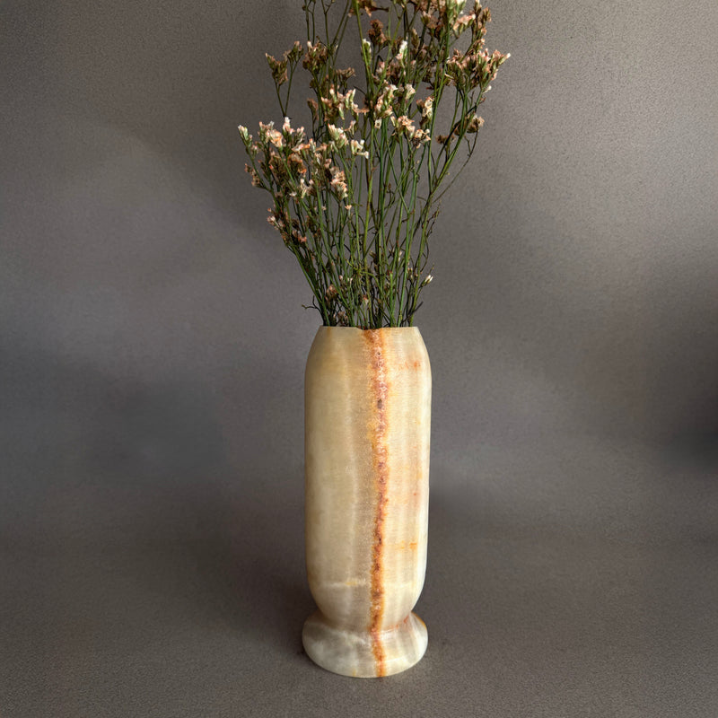 Peach Honey Amber Onyx Stone Vase with dried plants on a gray background