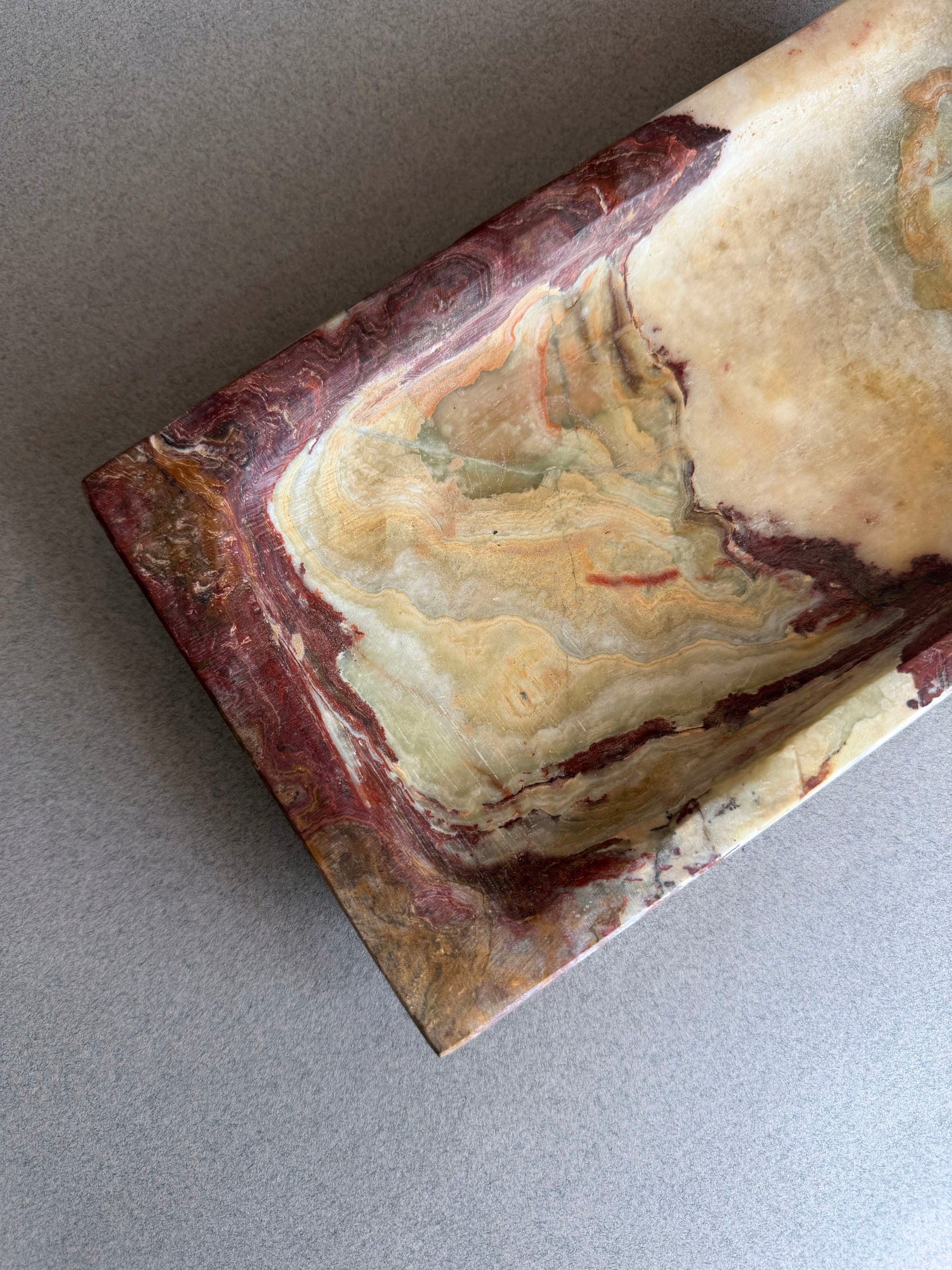 Wabi sabi onyx vanity tray with sculptural form and natural purple and amber stone movement
