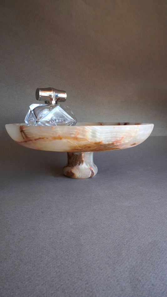 pink onyx Decorative tray with a marble-like finish on a gray background
