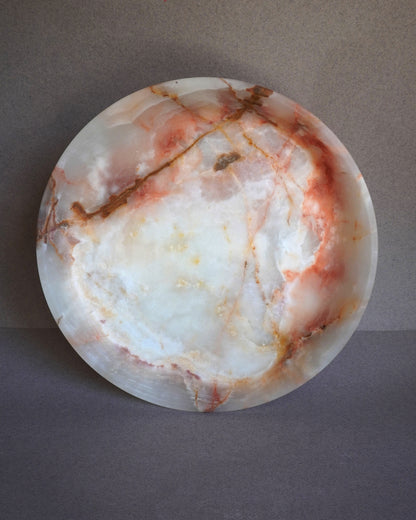 pink onyx  Marble-patterned stone on a gray background