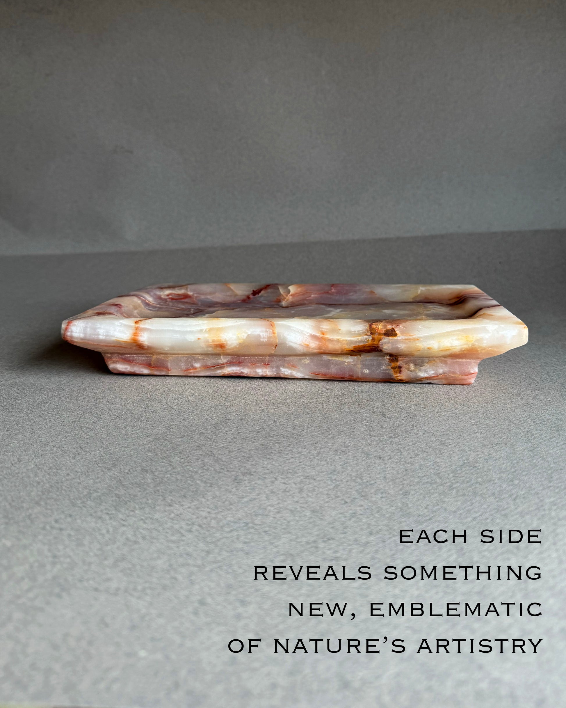 Top view of hand carved onyx tray showing soft purple and blush stone pattern
