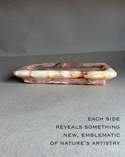 Top view of hand carved onyx tray showing soft purple and blush stone pattern
