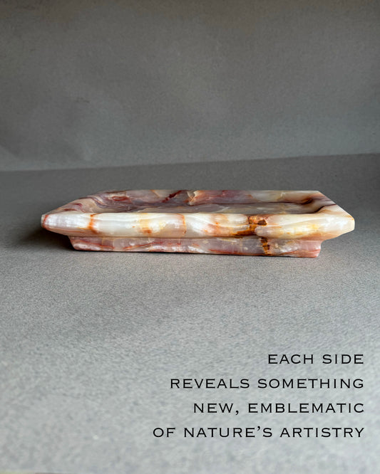 Top view of hand carved onyx tray showing soft purple and blush stone pattern
