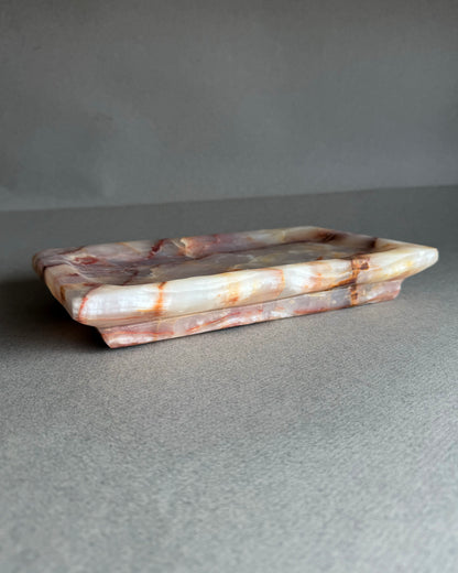 Side profile of stepped edge onyx tray with raw stone texture
