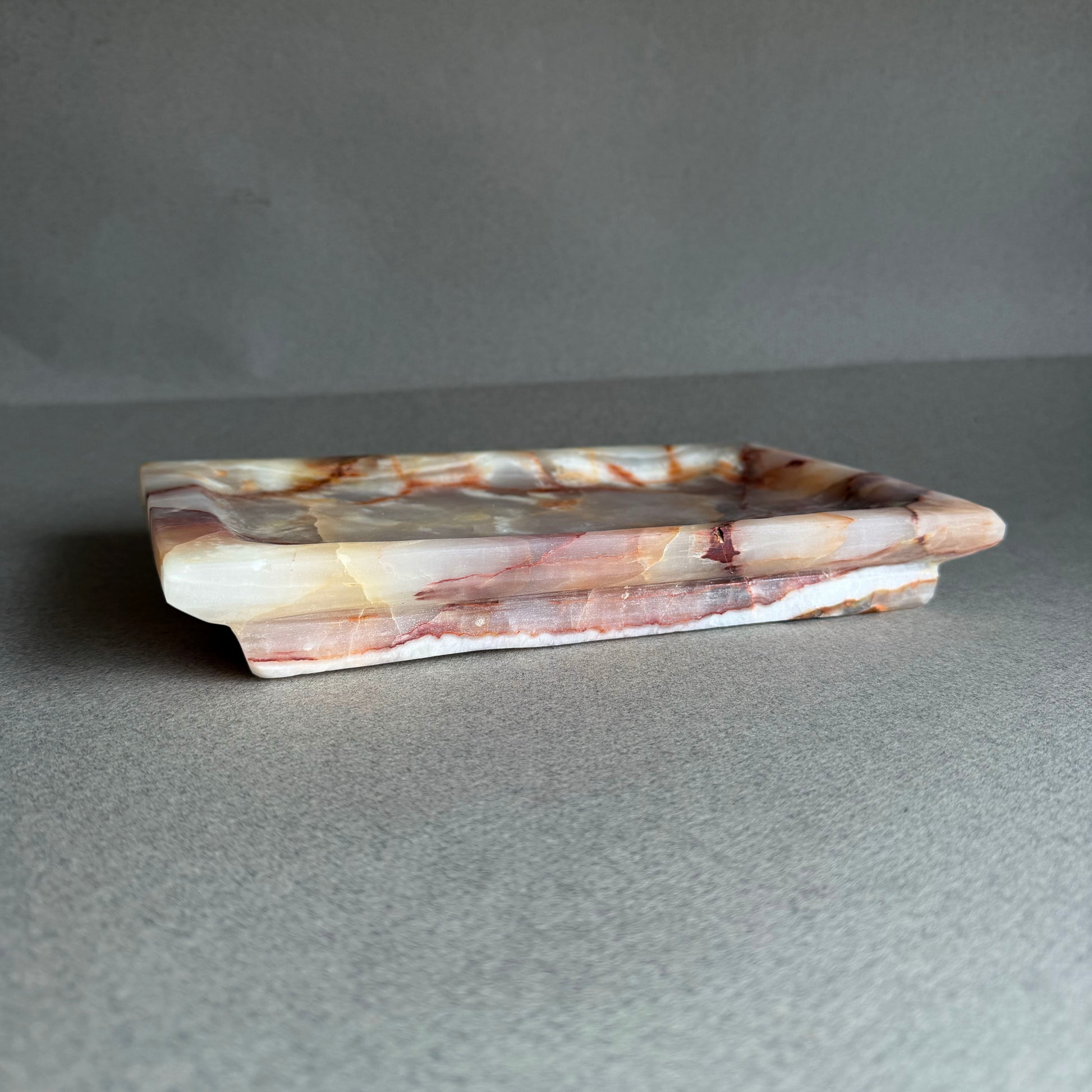 Onyx catchall tray styled on a neutral surface for jewelry or essentials
