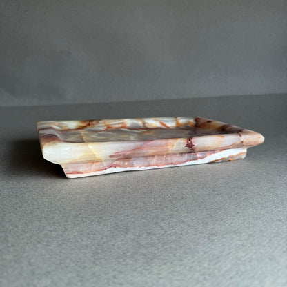 Onyx catchall tray styled on a neutral surface for jewelry or essentials
