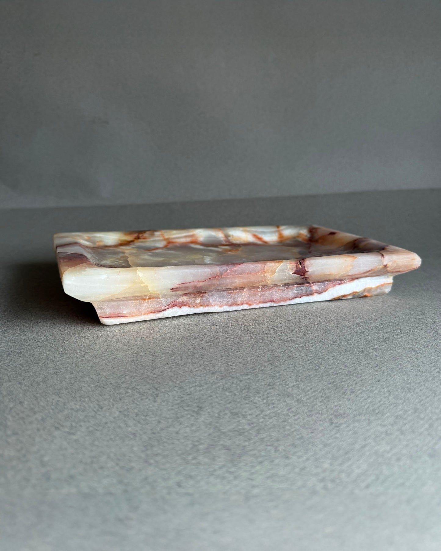 Rectangular onyx vanity tray carved from a single block of natural stone
