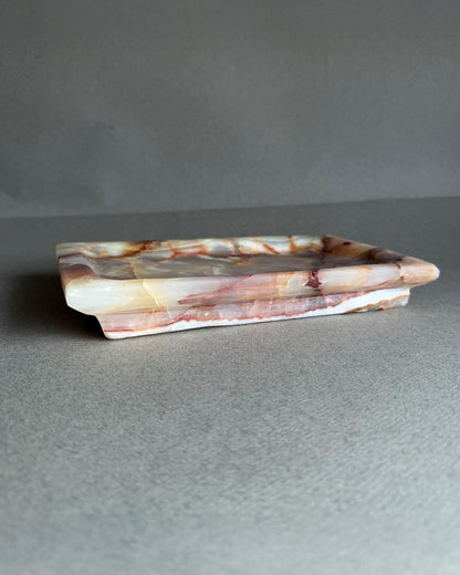 Rectangular onyx vanity tray carved from a single block of natural stone
