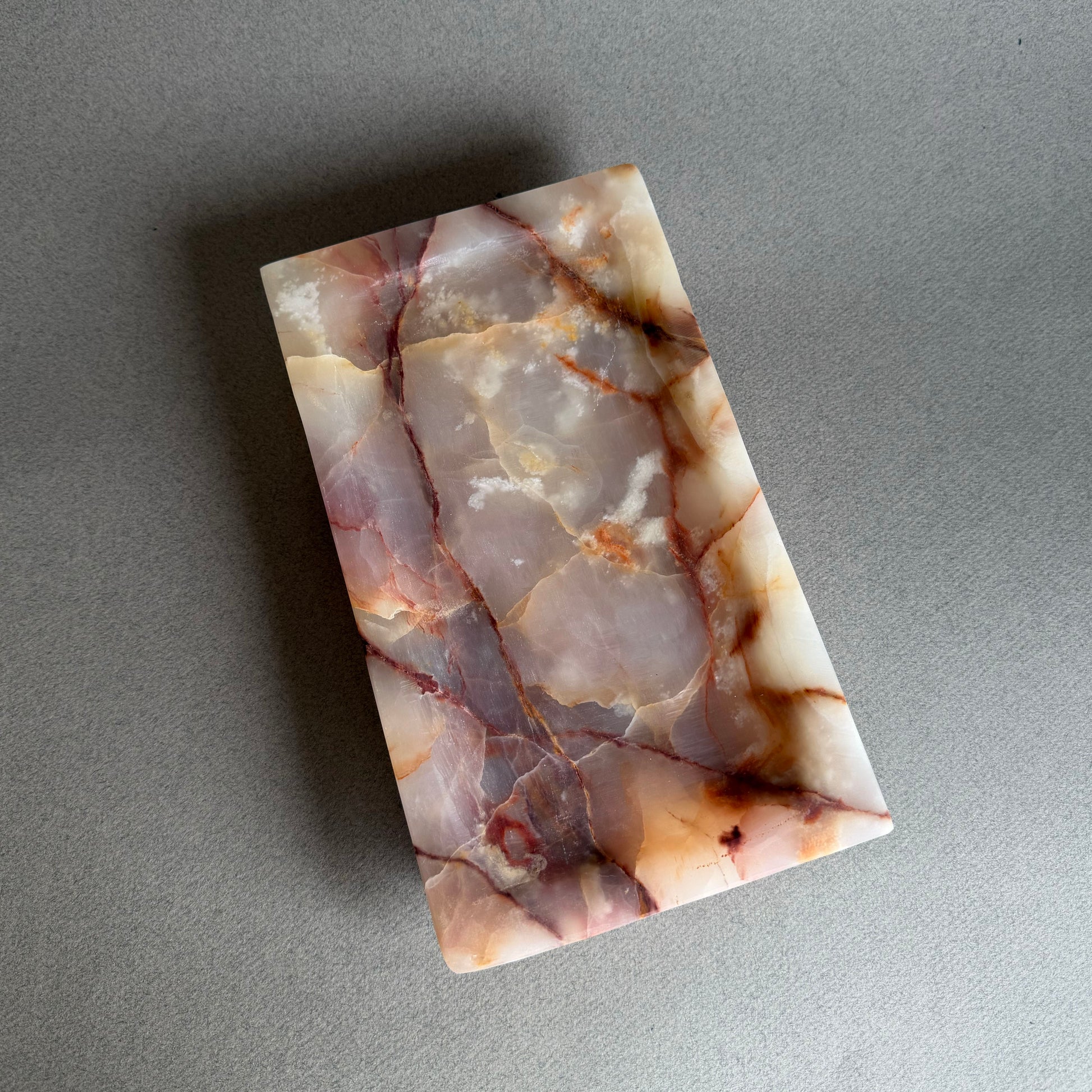 Blush pink and lavender onyx catchall tray with ivory and amber veining
