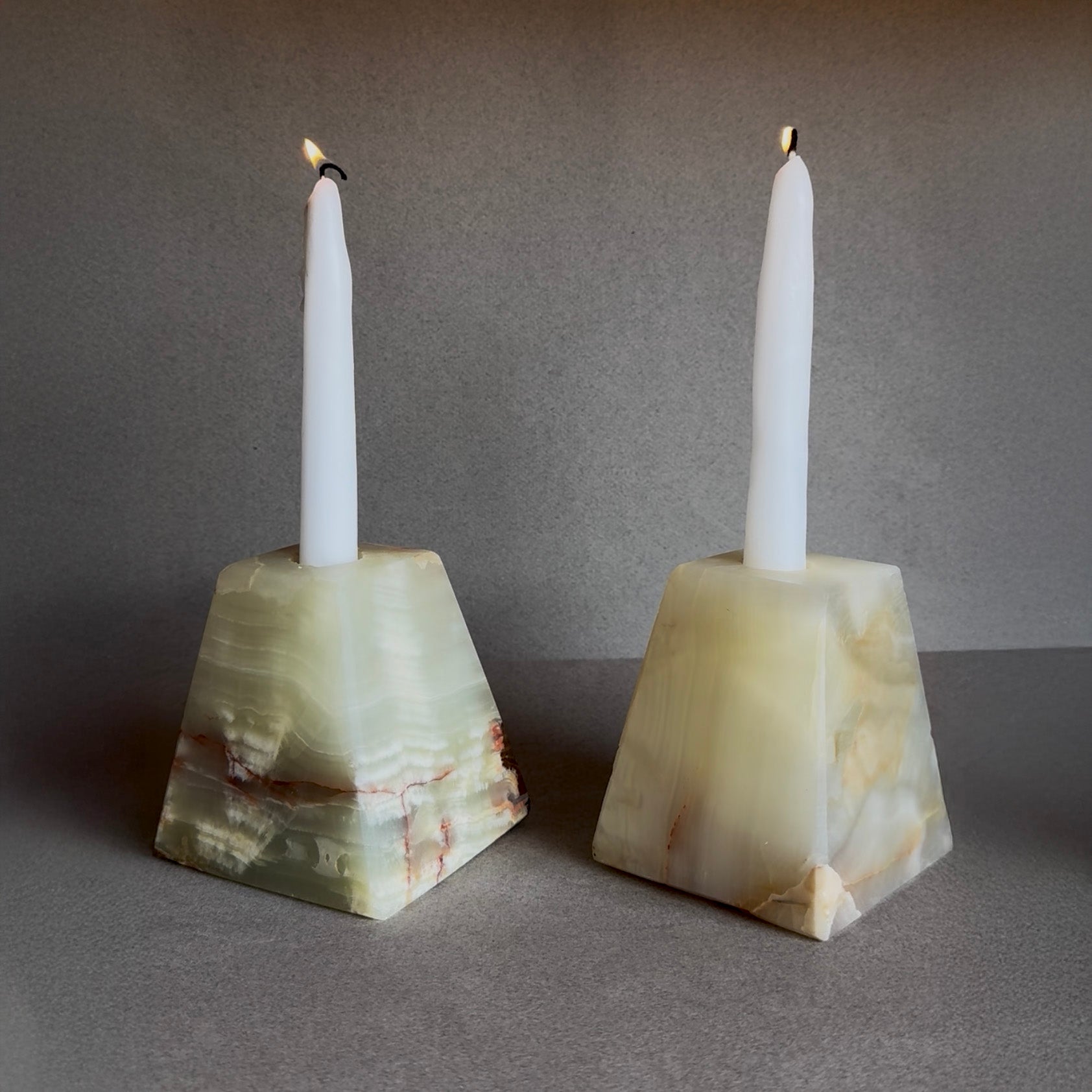 Pair of amber green and cream onyx candle holders with pyramid shape

