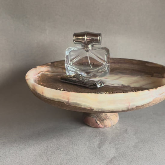 Unique hand-carved onyx pedestal bowl with earthy tones, sustainable luxury home decor piece for table styling, fruit, or jewelry storage.