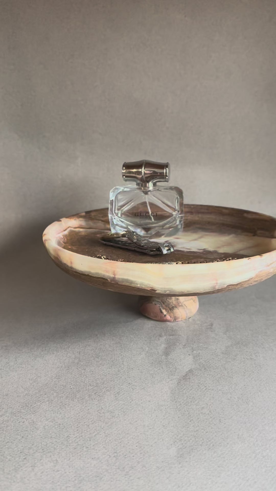 Unique hand-carved onyx pedestal bowl with earthy tones, sustainable luxury home decor piece for table styling, fruit, or jewelry storage.