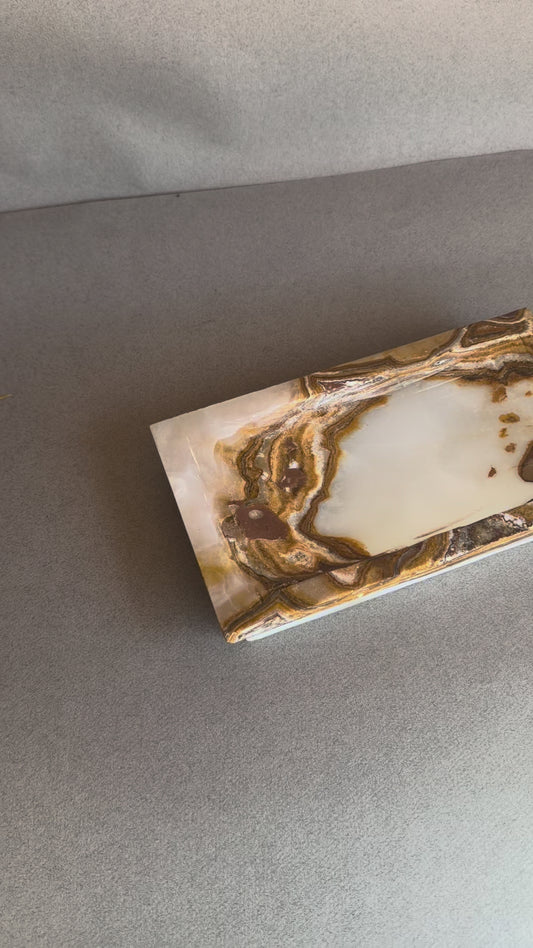 Rectangular raw onyx stone tray with sculpted edges and warm brown contrast
