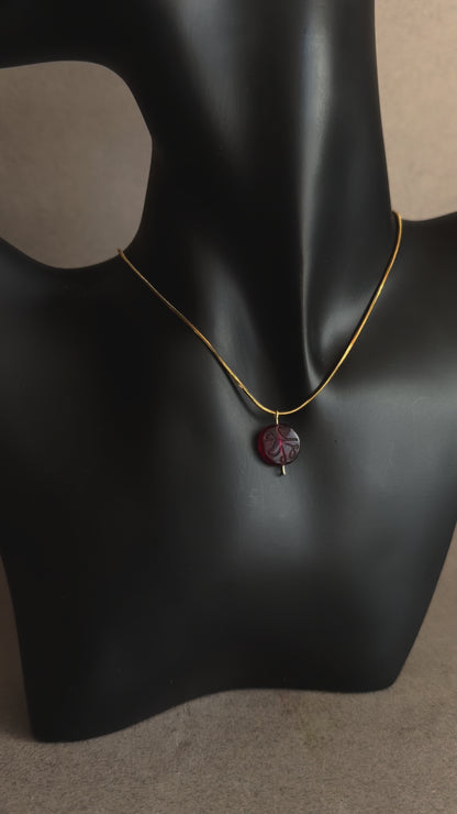 Minimal red garnet Mecca bead necklace with engraved detailing on gold snake chain
