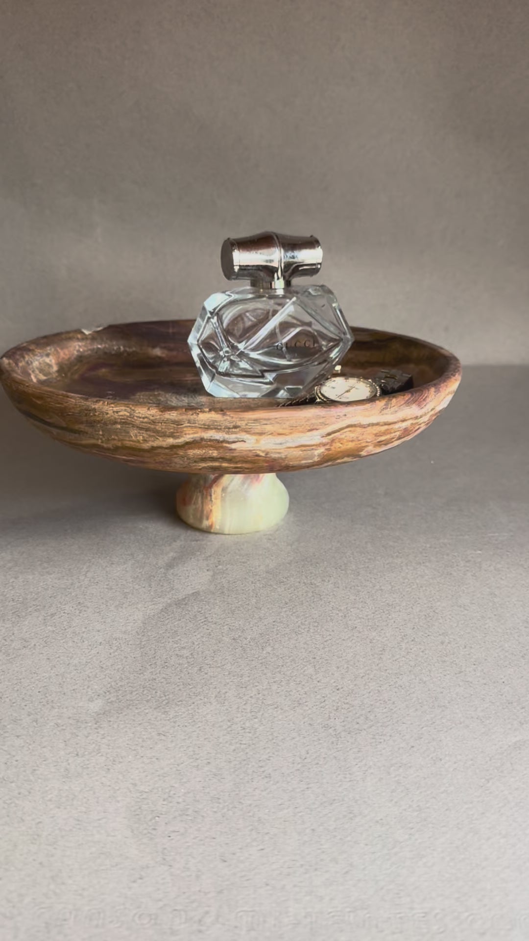 Organic modern pedestal bowl carved from onyx stone, versatile as a fruit bowl, jewelry catchall, or sculptural centerpiece.