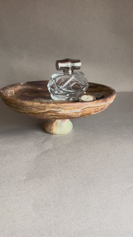 Organic modern pedestal bowl carved from onyx stone, versatile as a fruit bowl, jewelry catchall, or sculptural centerpiece.
