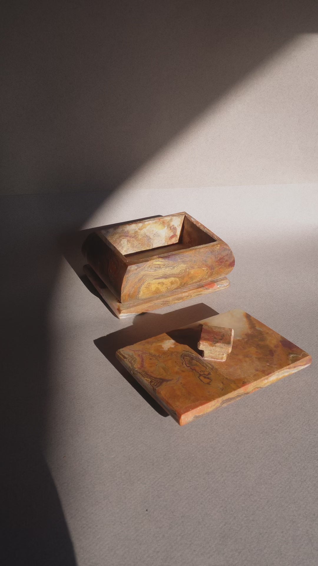Natural stone onyx box with lid removed showing storage interior for jewelry or keepsakes  
