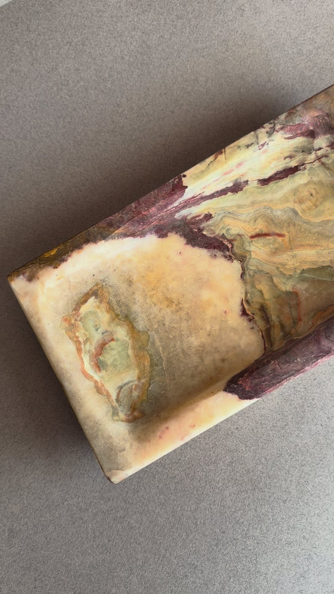 Rectangular natural onyx tray featuring deep plum, brown, and cream stone layers with stepped edge design
