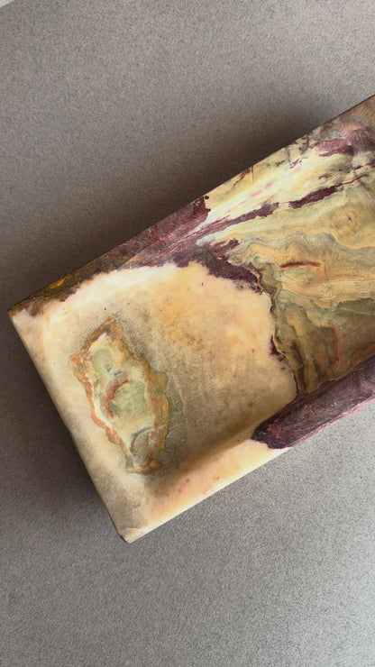 Rectangular natural onyx tray featuring deep plum, brown, and cream stone layers with stepped edge design
