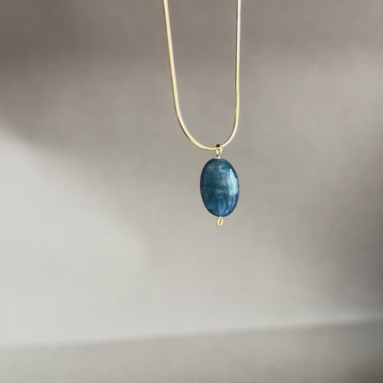 blue kyanite gemstone pendant on a gold snake chain necklace iridescent stone minimalist necklace jewelry