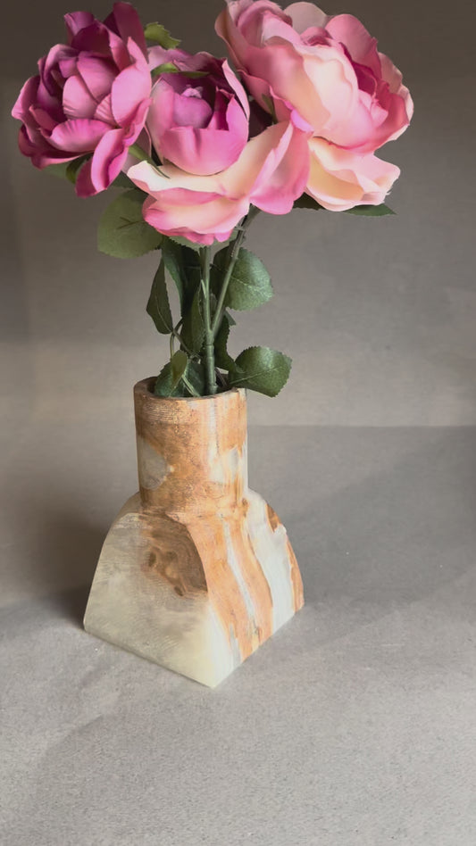 Hand-carved amber onyx vase with geometric square base and cylindrical top, styled with eucalyptus stems.