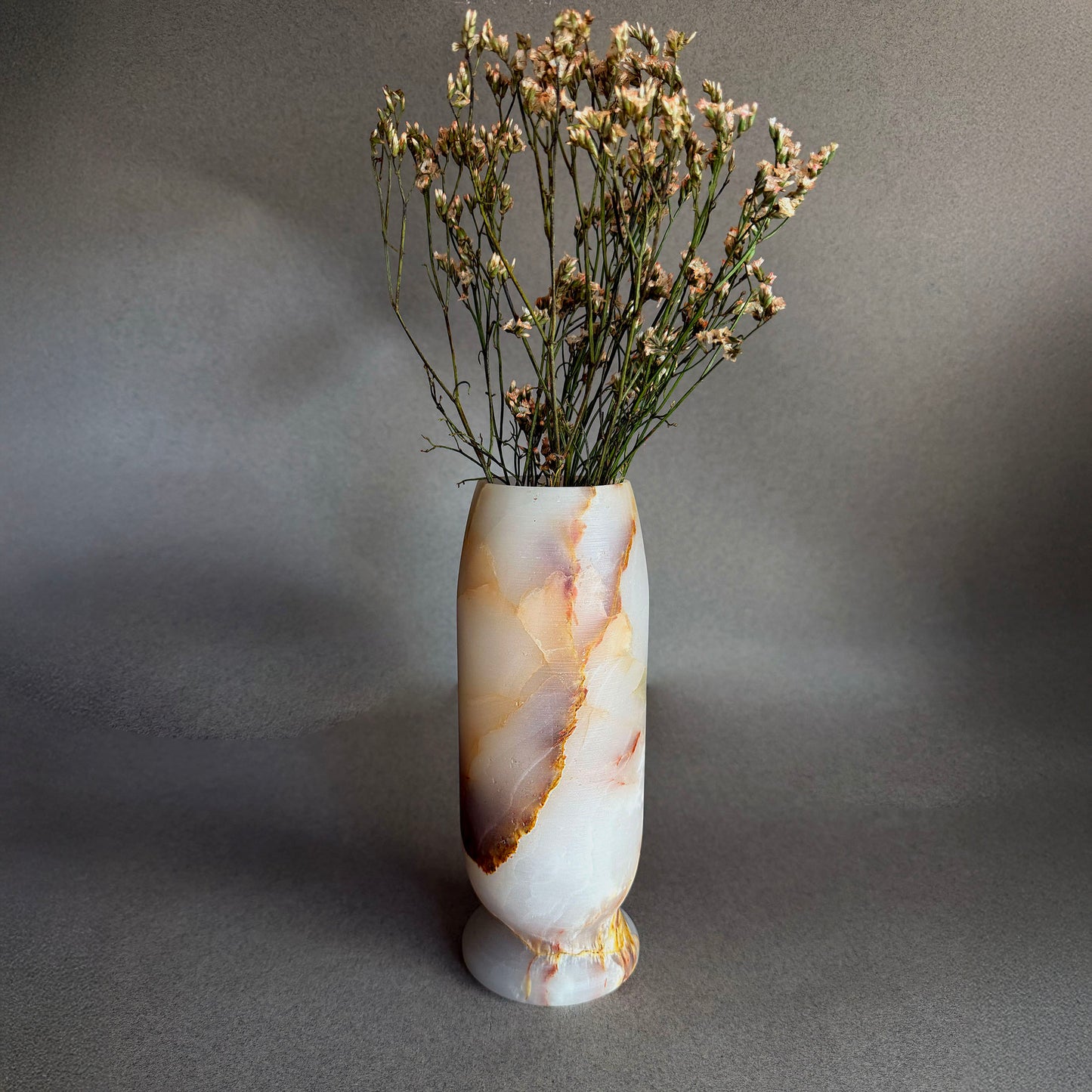 honey onyx white honey vase with dried flowers on a gray background
