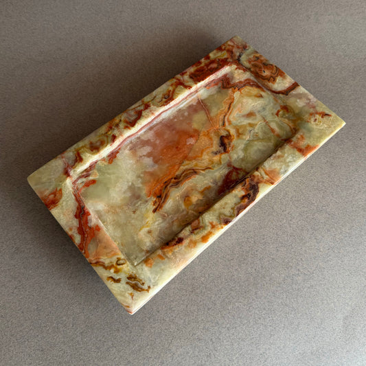 Rectangular onyx tray with marbled pattern on a gray background