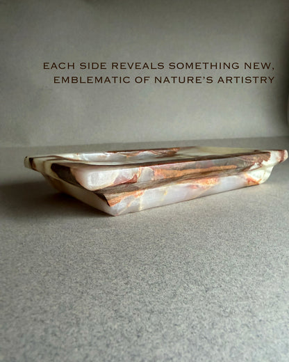 Decorative stone tray with natural patterns on a gray surface, text overlay about nature's artistry.