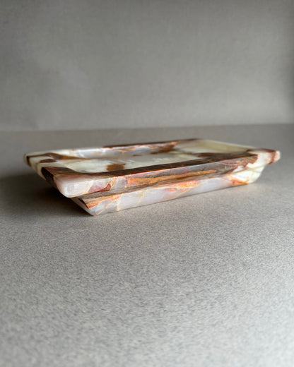 Rectangular ceramic tray with marbled pattern on a gray surface