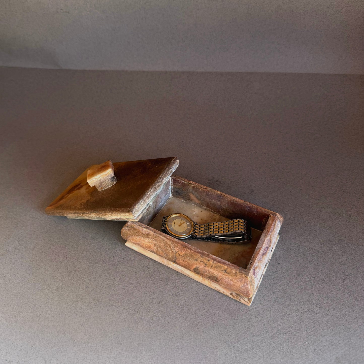Open onyx trinket box showing natural stone interior and removable lid
