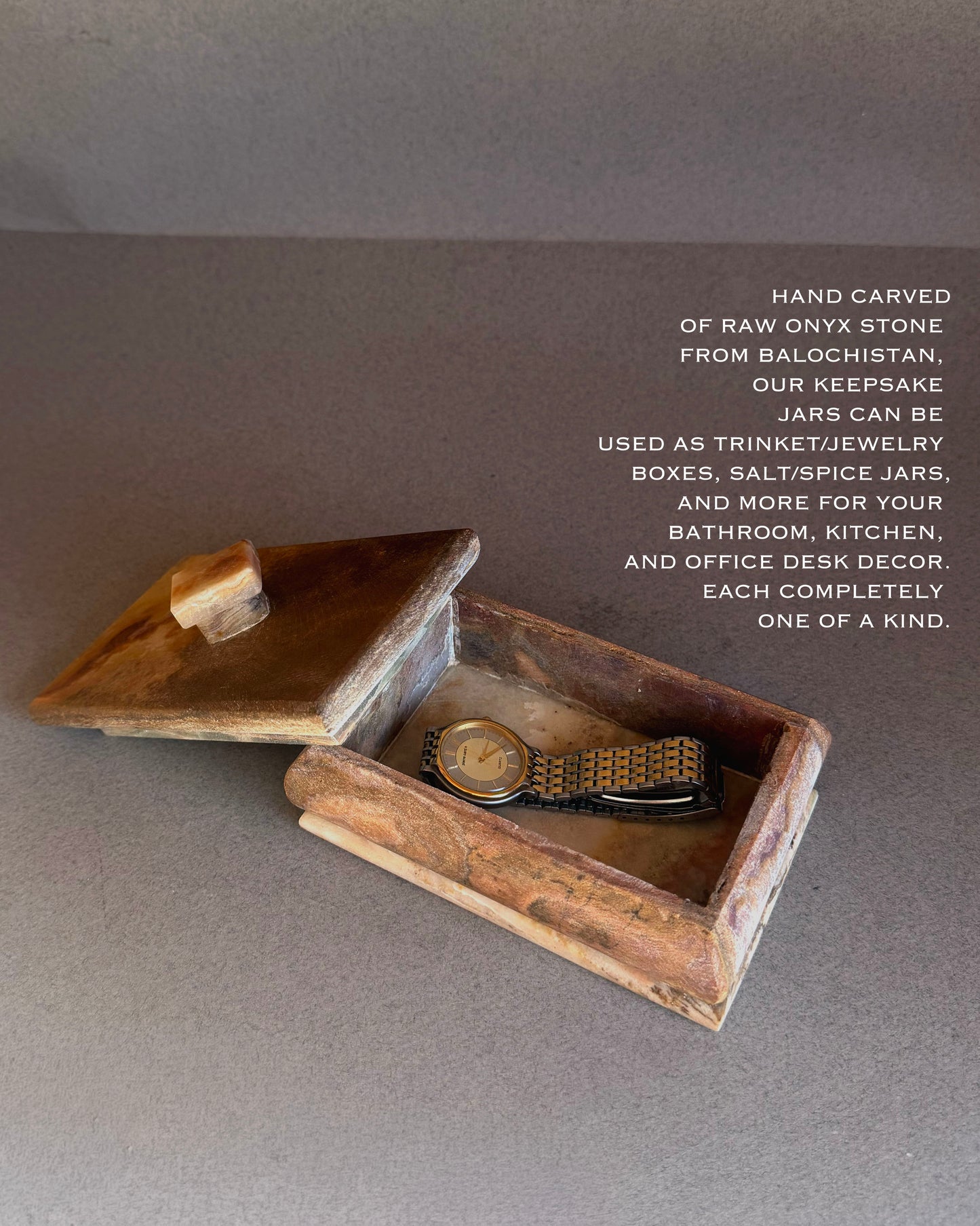 Onyx trinket box styled as jewelry storage with watch inside
