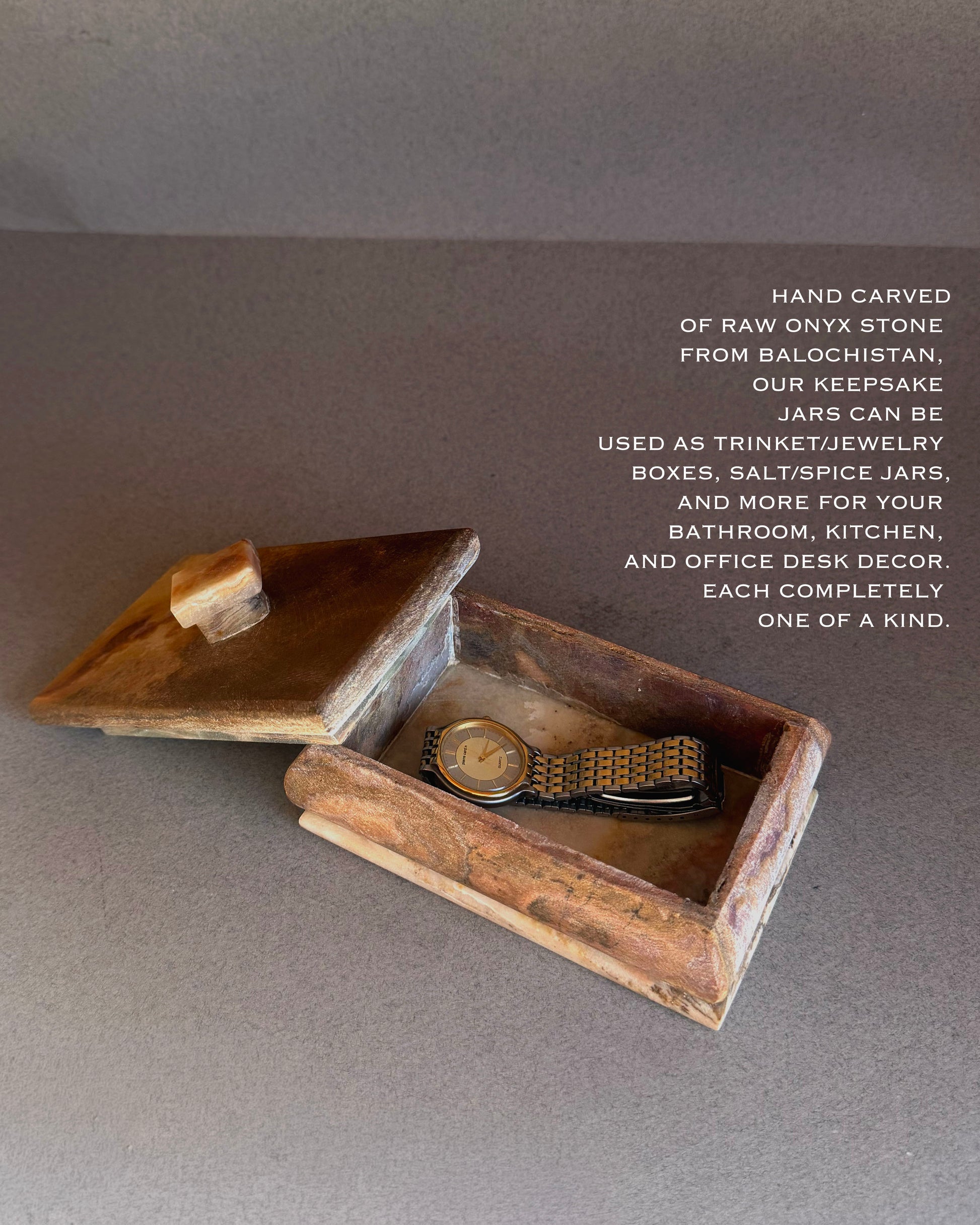 Onyx trinket box styled as jewelry storage with watch inside