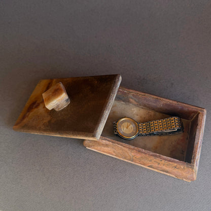 Close up of raw onyx lid showing natural veining and matte stone texture
