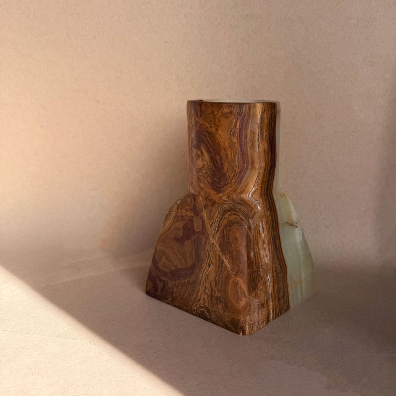onyx vase with natural grain pattern on a neutral background