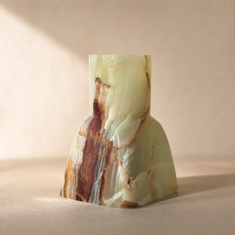 Marble-textured green onyx vase sculptural saéa designs on a beige background