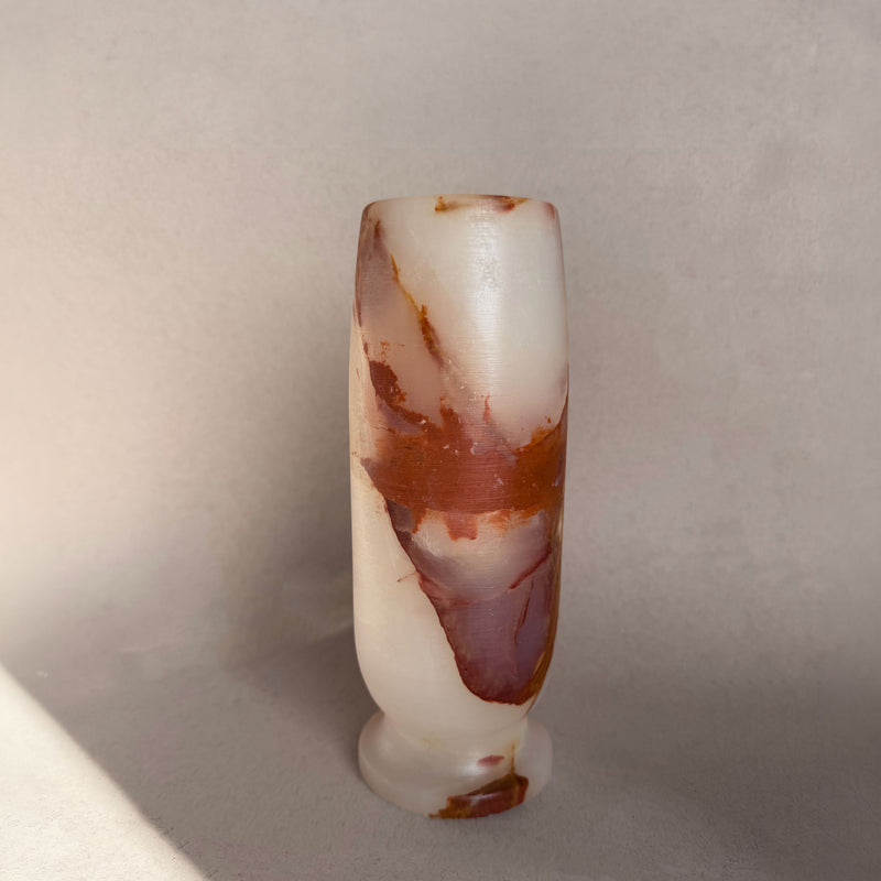 Marbled stone object on a neutral background