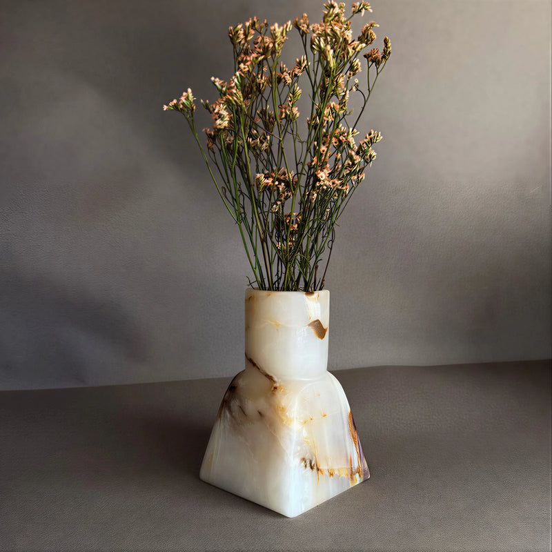 White ONyx Vase with a natural stone pattern containing dried flowers on a beige background