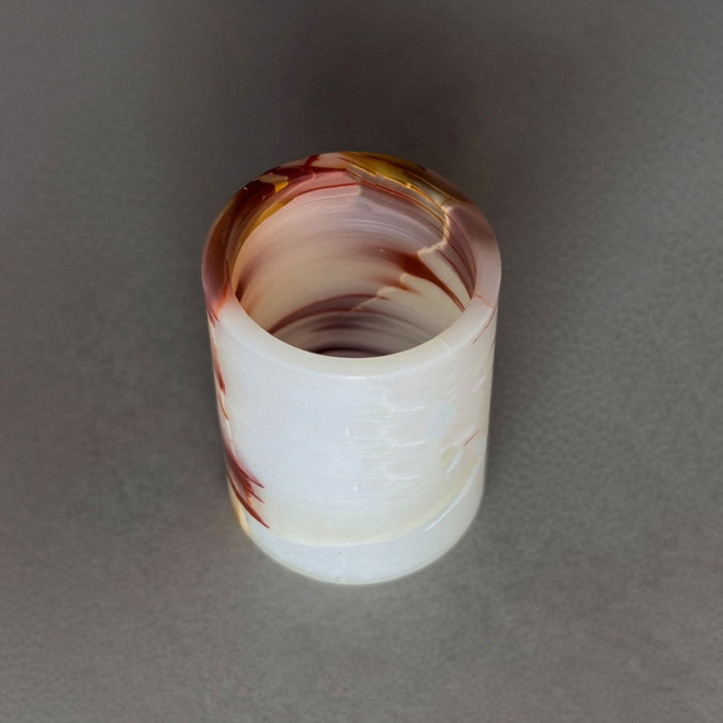 Hand-carved pink onyx vessel in cream, rust, and amber — toothbrush holder, utensil crock, pen cup, or candle vessel. One of a kind, sealed with beeswax, shipped plastic-free from San Diego. Shop SAÉA.
