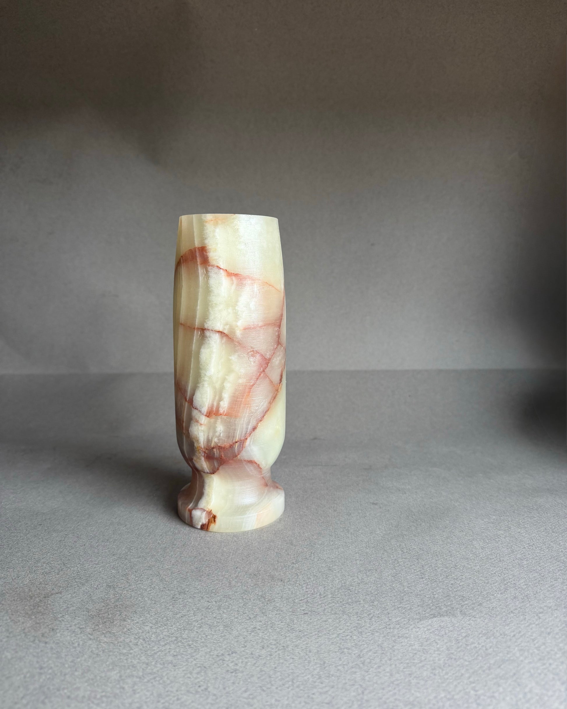 Marble-textured vase on a gray background