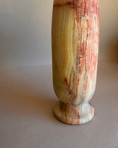 Decorative vase with a striped pattern on a beige background