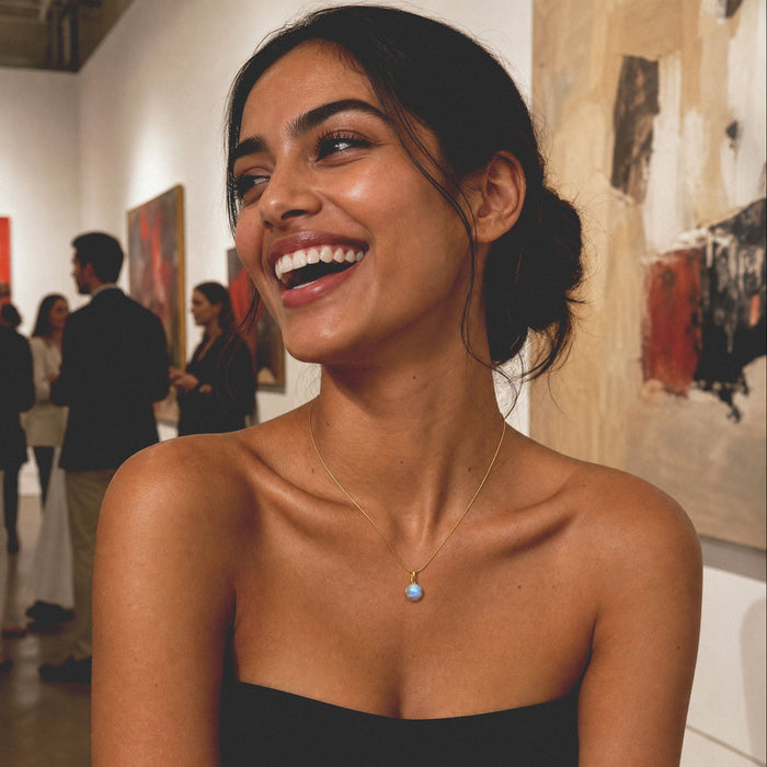 Woman smiling in an art gallery with people in the background