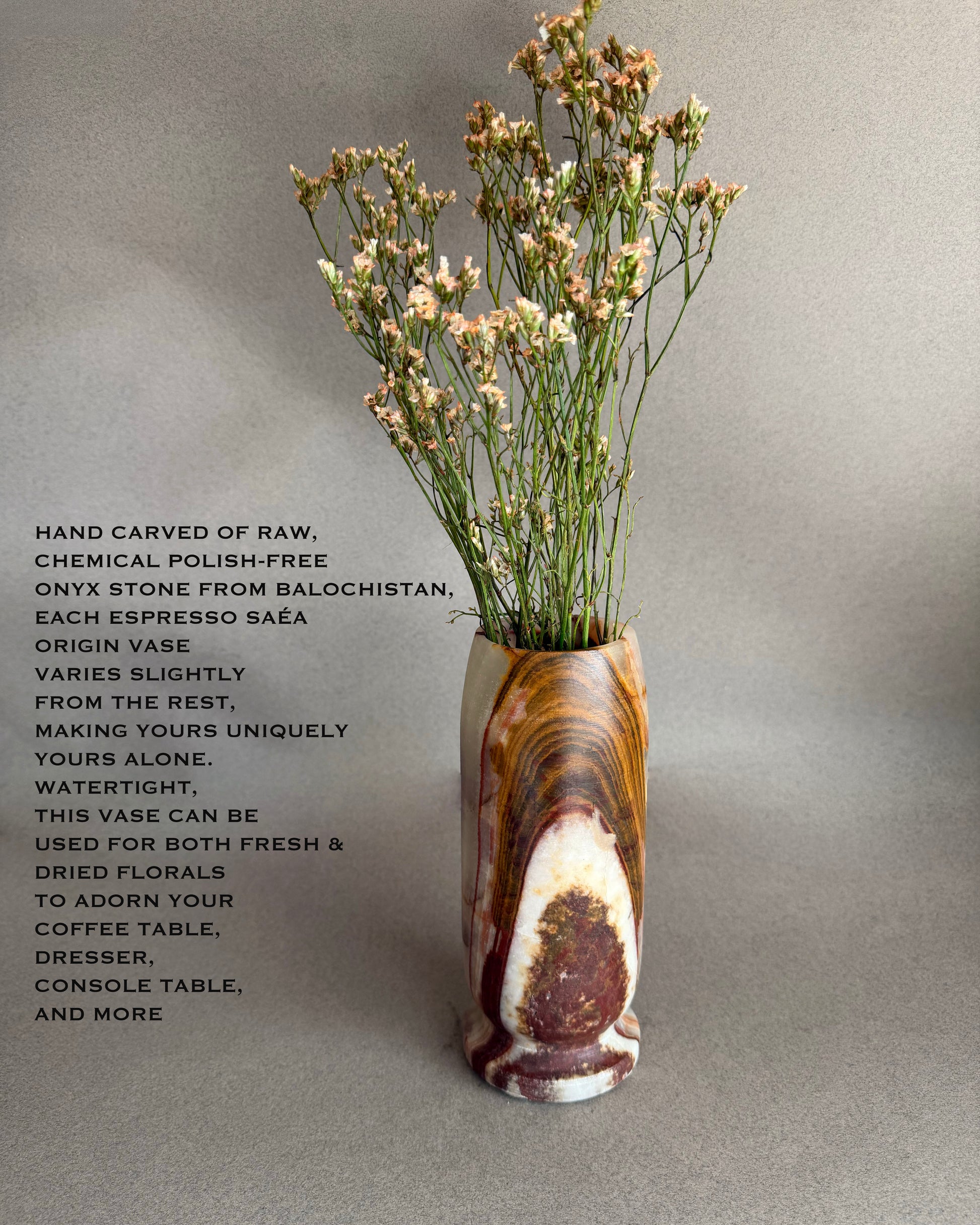 Decorative onyx brown vase with dried flowers on a gray background