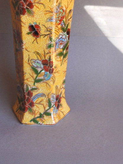 Decorative vase with floral patterns on a plain background