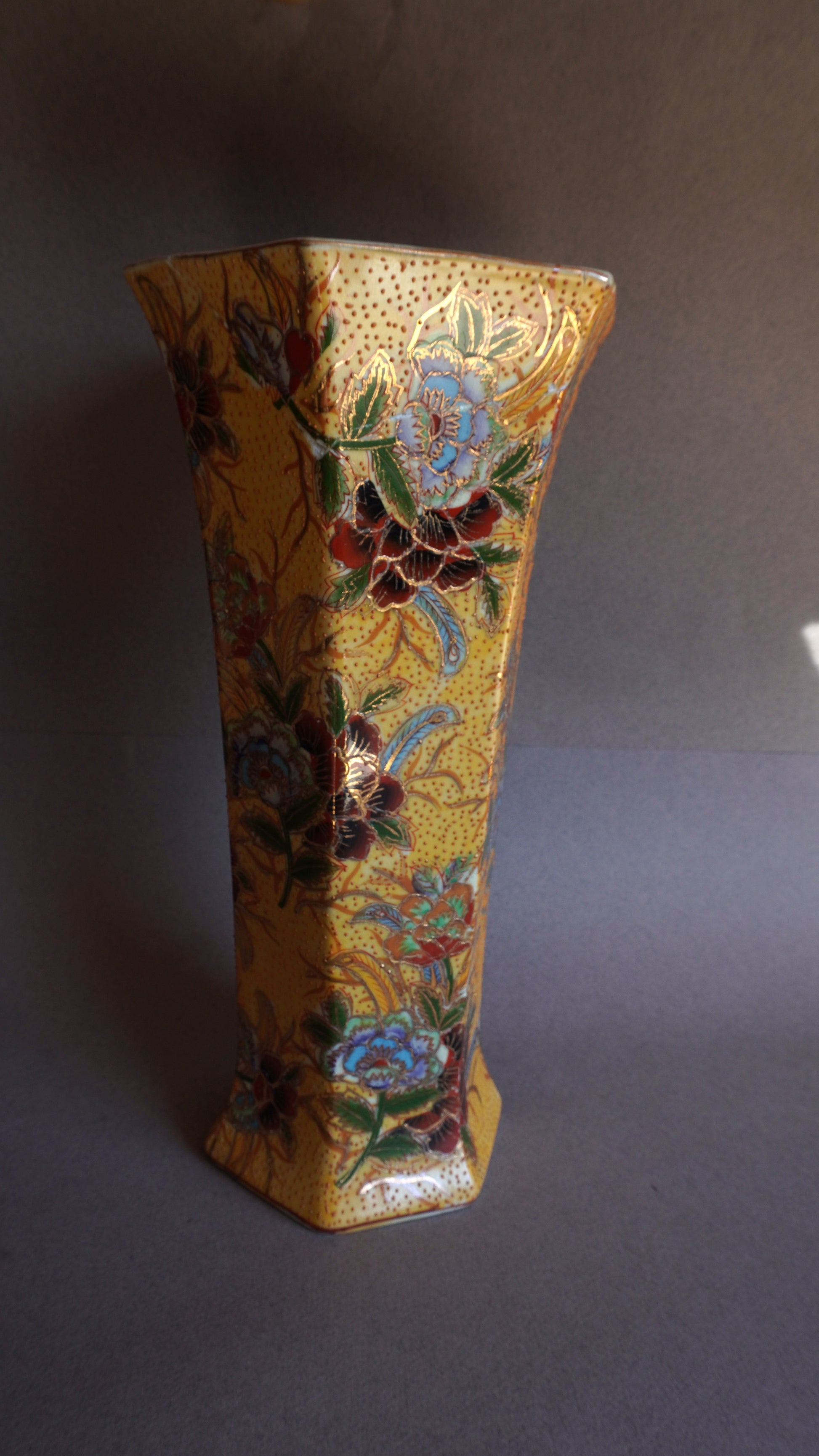 Decorative vase with floral patterns on a plain background